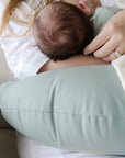 newborn baby breastfeeding on snuggle me organic feeding support nursing pillow in slate