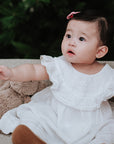 baby elsie wearing purebaby organic ruffle dress special occasion organic cotton clothes