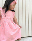 girl in pink organic cotton swallow dress puerbaby organic