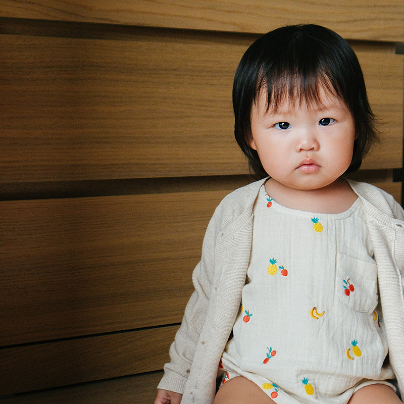 baby in striped overalls organic cotton baby clothes