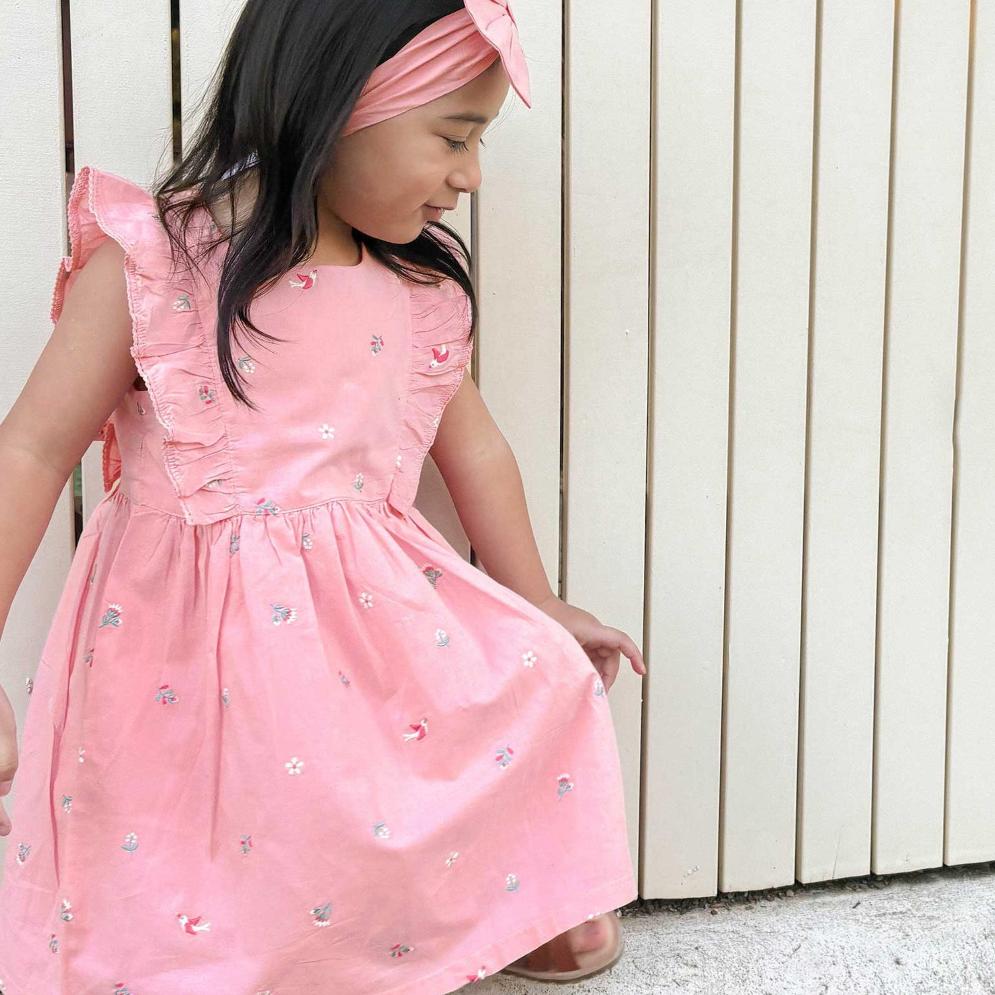 girl in pink organic cotton swallow dress puerbaby organic