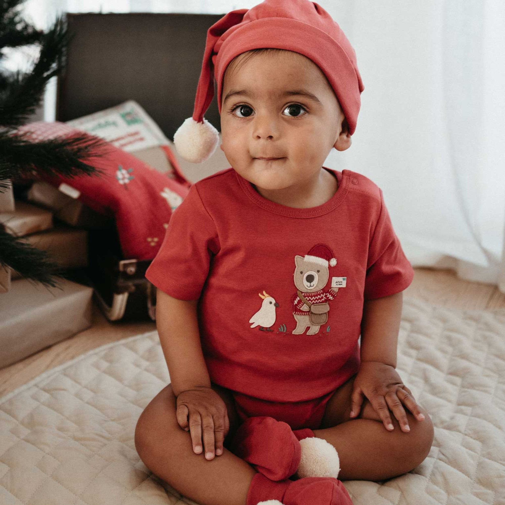 baby in purebaby organic postie santa bodysuit baby christmas outfit