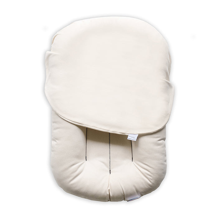 baby sitting on organic cotton bed lounger