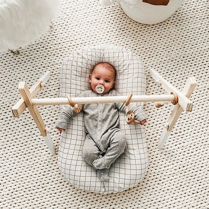wooden baby gym baby in lounger